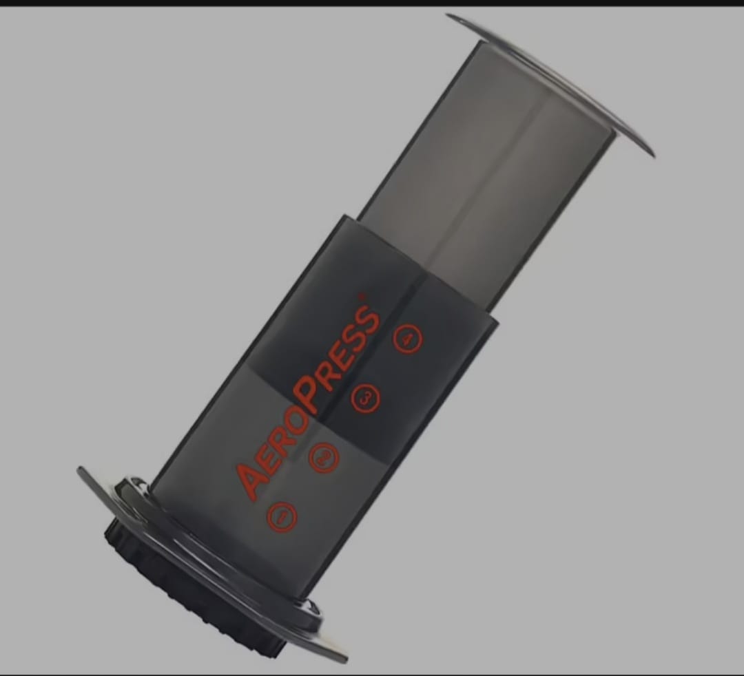 AeroPress coffee maker in use showing air pressure brewing method for espresso style smooth coffee extraction